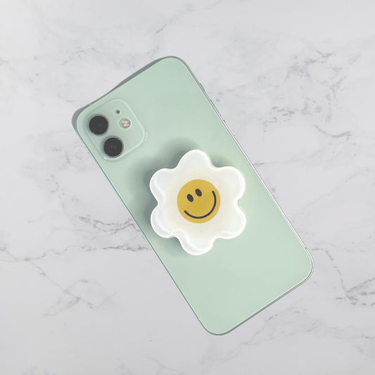 white and yellow smiley face flower phone bracket pop socket